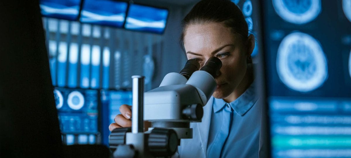 Biotechnology company - woman using a microscope