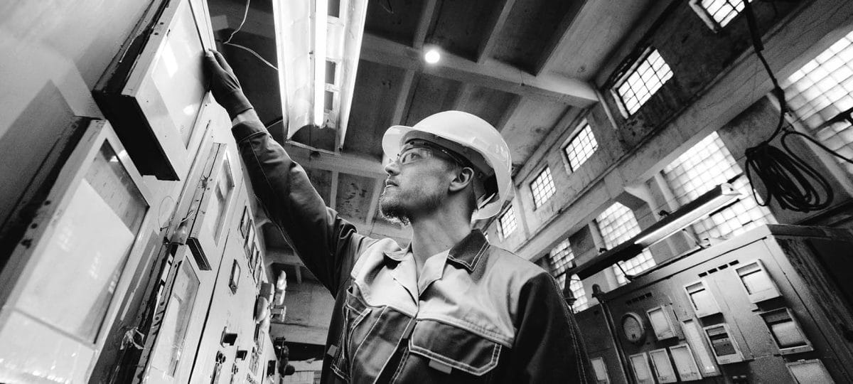 a worker performing maintenance work industrial setting