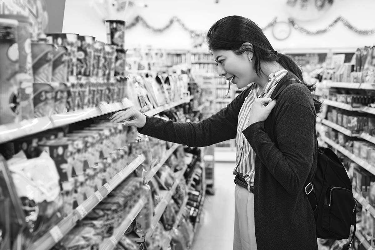 a woman looking at products in a convenience store
